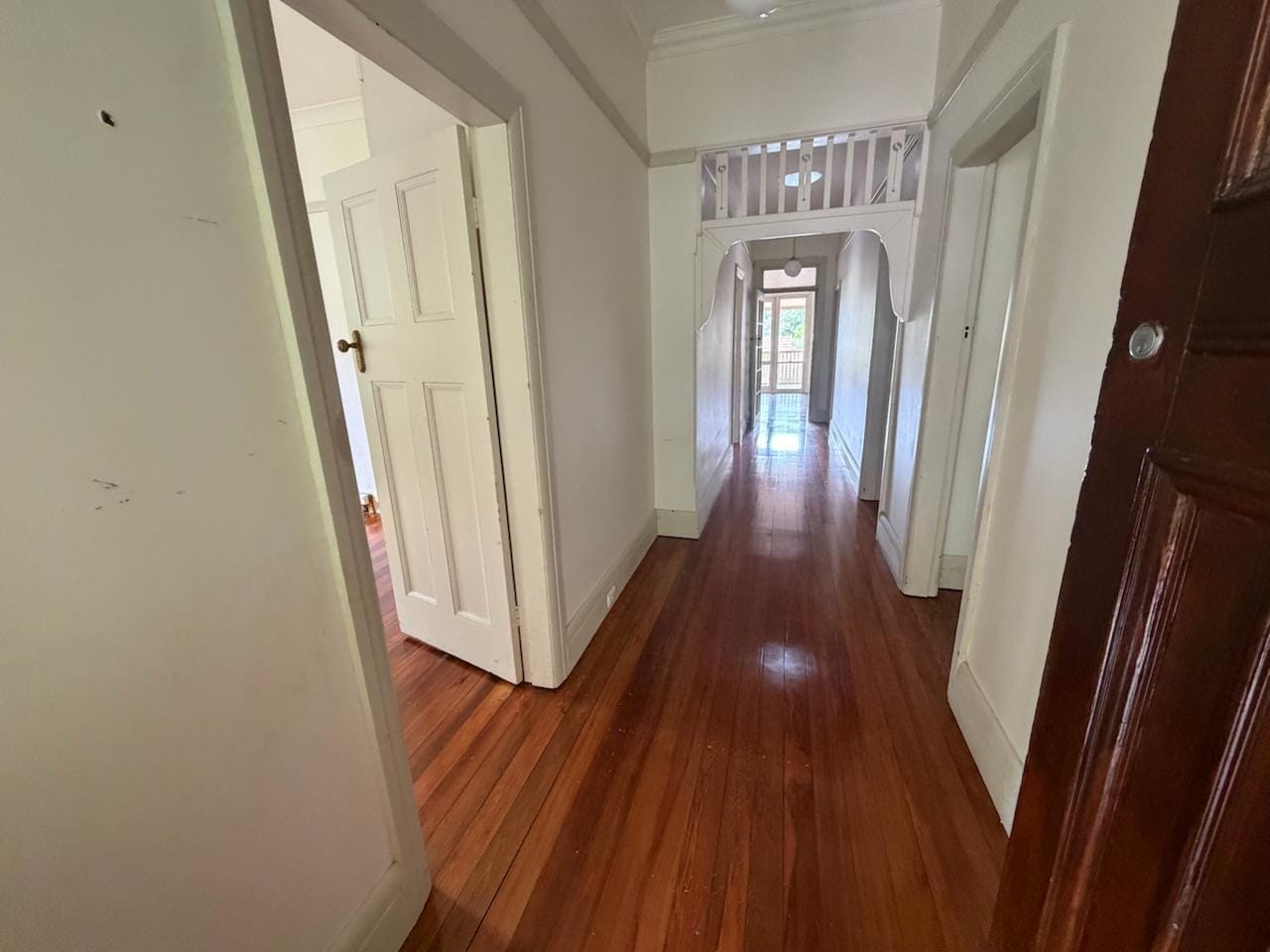 Clean white hallway walls, skirting boards and timber floors after vacate clean